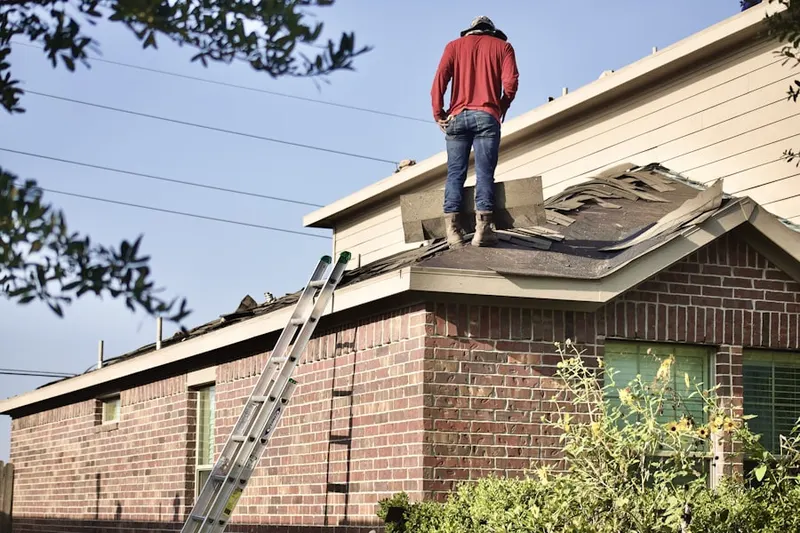 Professional roofer working on a residential roof in Herndon